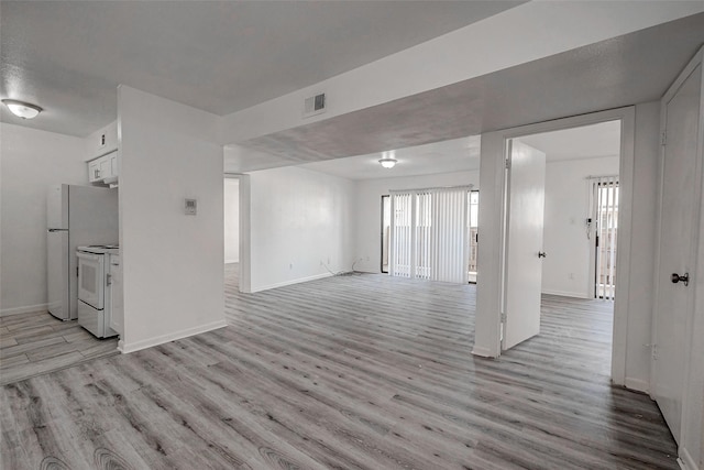 unfurnished living room with light hardwood / wood-style flooring