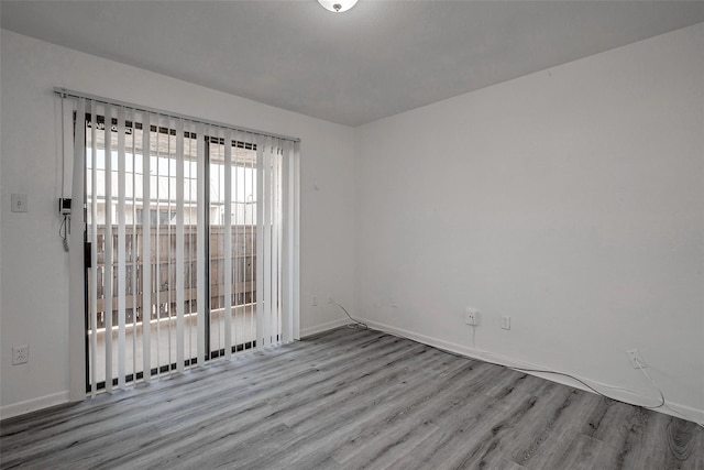 spare room with light hardwood / wood-style flooring