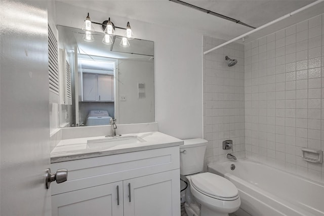 full bathroom featuring toilet, vanity, and tiled shower / bath