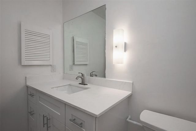 bathroom with toilet and vanity