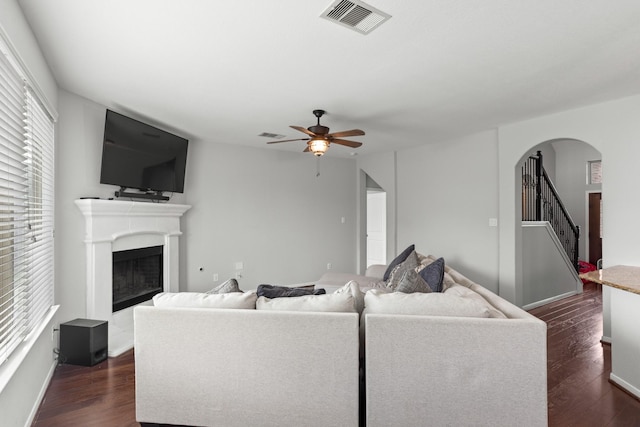 living room featuring dark hardwood / wood-style flooring and ceiling fan