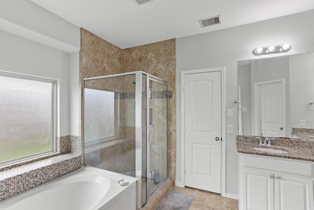 bathroom with shower with separate bathtub, vanity, and tile patterned floors