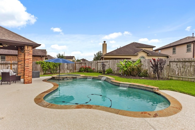 view of swimming pool with a patio, pool water feature, and an in ground hot tub