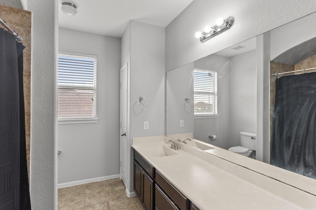 bathroom with toilet and vanity