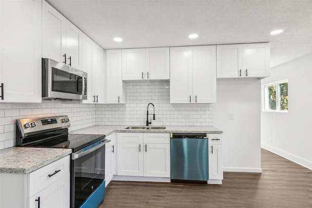 kitchen featuring stainless steel appliances, white cabinetry, and sink