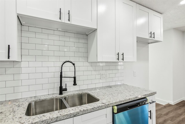 kitchen with sink, white cabinets, tasteful backsplash, and dishwasher