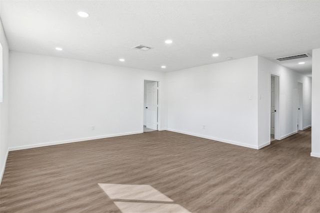 empty room with dark hardwood / wood-style flooring