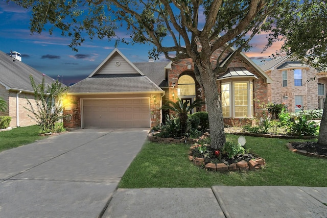 view of front of home featuring a garage and a lawn