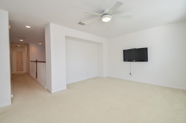 empty room featuring light carpet and ceiling fan