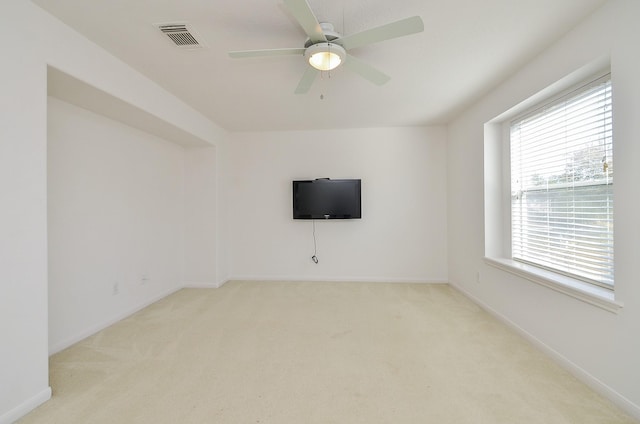 carpeted spare room with ceiling fan