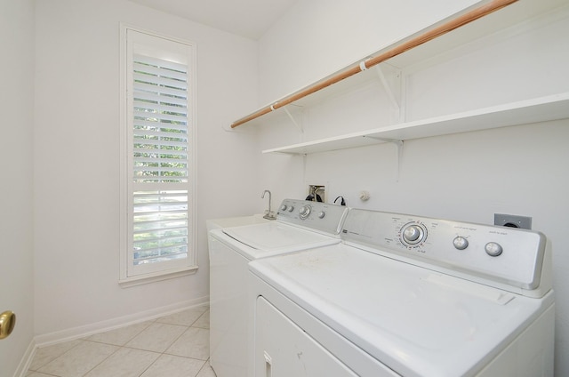 laundry area featuring sink, light tile patterned floors, and independent washer and dryer