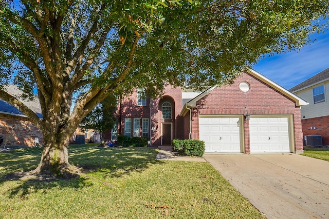 view of front of property featuring a front lawn, central AC, and a garage