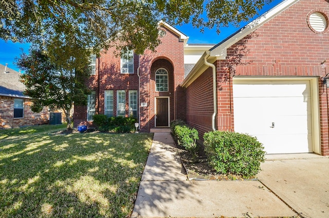 view of property with a garage and a front lawn