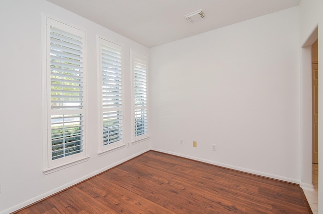 spare room with wood-type flooring