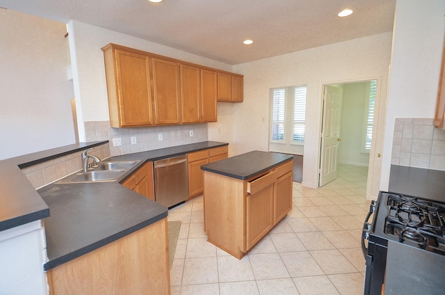 kitchen with dishwasher, black gas range, a center island, decorative backsplash, and sink