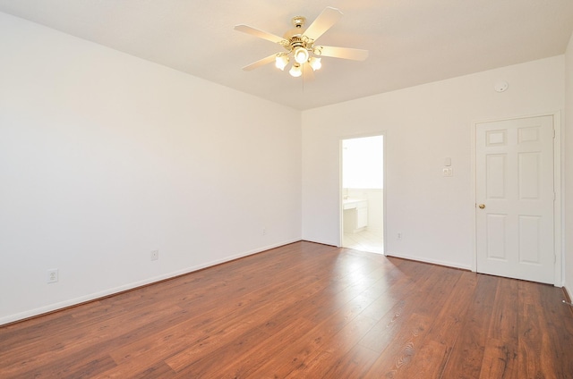 unfurnished room with ceiling fan and dark hardwood / wood-style flooring