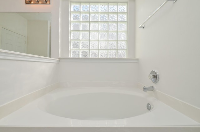 bathroom with a tub to relax in