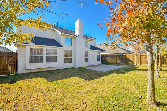 back of house with a yard and a patio