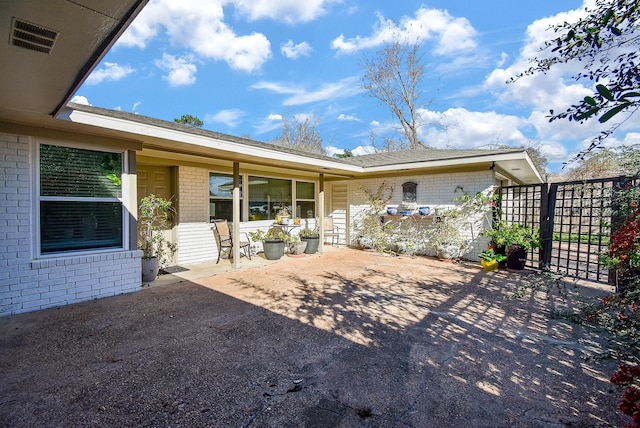 back of property featuring a patio area