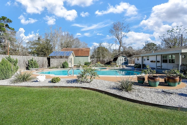 view of swimming pool with a storage shed