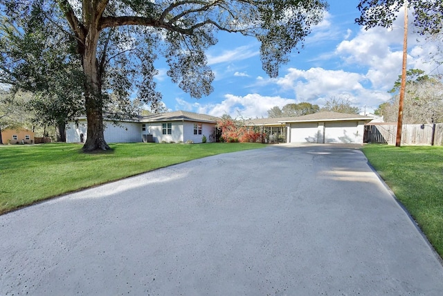 single story home with a garage and a front lawn