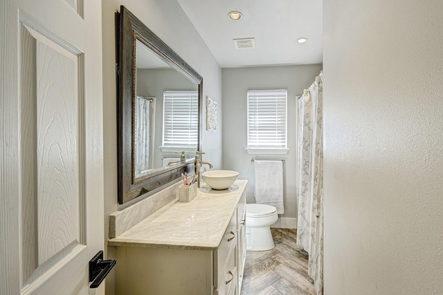 bathroom with toilet and vanity