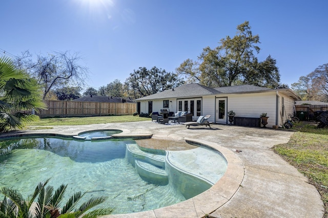 view of pool featuring an in ground hot tub, french doors, and a patio