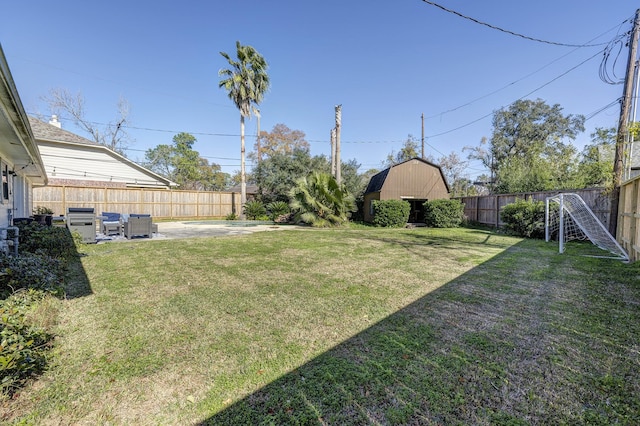 view of yard featuring a storage shed and a patio area