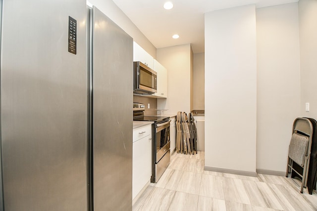 kitchen featuring appliances with stainless steel finishes and white cabinetry