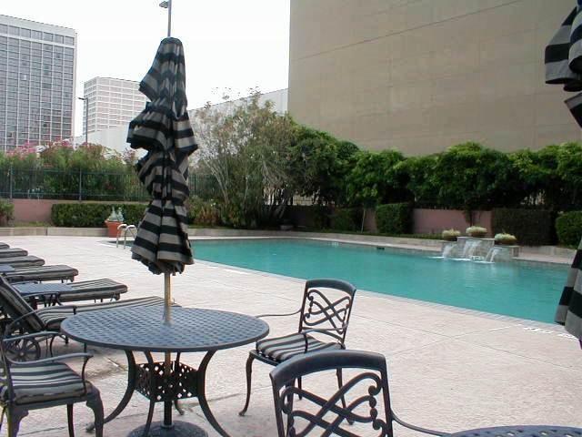 view of swimming pool featuring pool water feature and a patio area