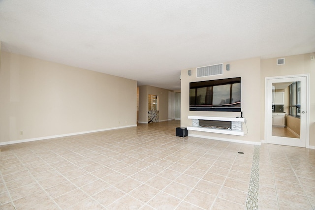 unfurnished living room with light tile patterned floors