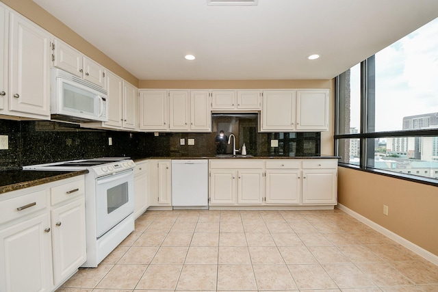 kitchen featuring white appliances, white cabinets, and sink