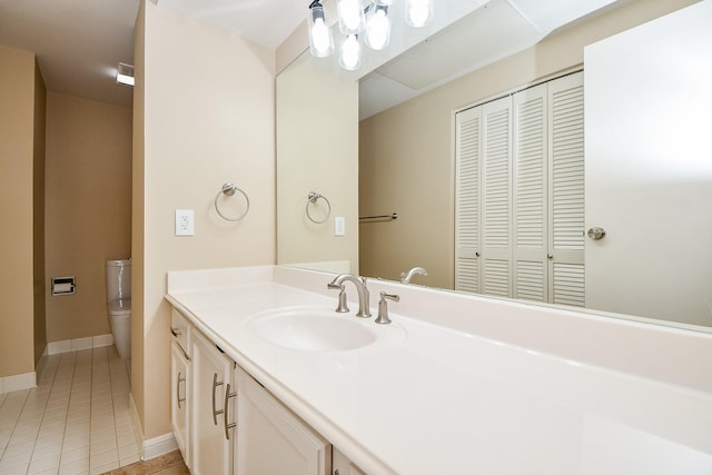 bathroom featuring vanity, tile patterned floors, and toilet