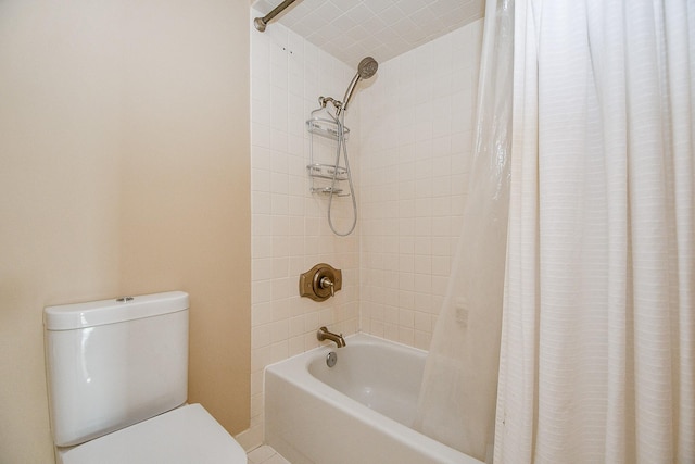 bathroom featuring shower / bath combo with shower curtain and toilet