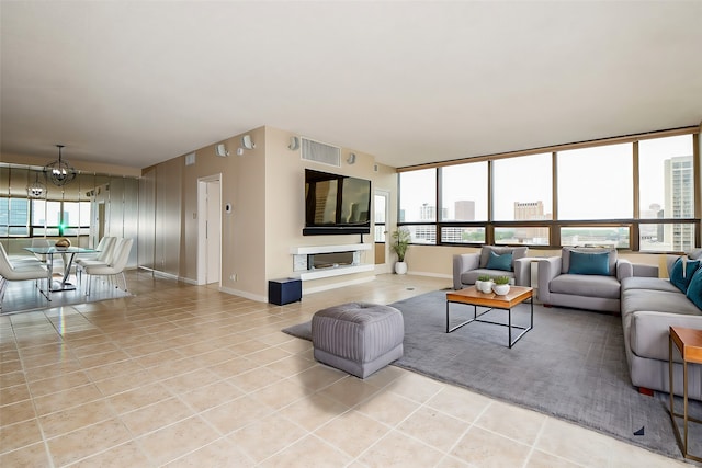 tiled living room featuring an inviting chandelier