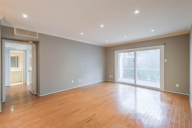 unfurnished room with ornamental molding and light hardwood / wood-style floors