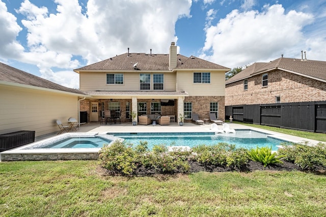 view of swimming pool with a yard, an in ground hot tub, a patio, and outdoor lounge area