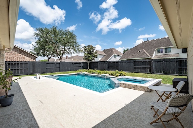 view of swimming pool with a patio area and an in ground hot tub