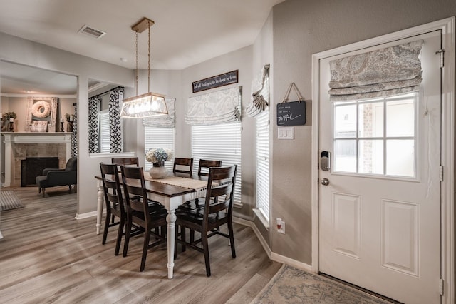 dining space with a fireplace and hardwood / wood-style flooring