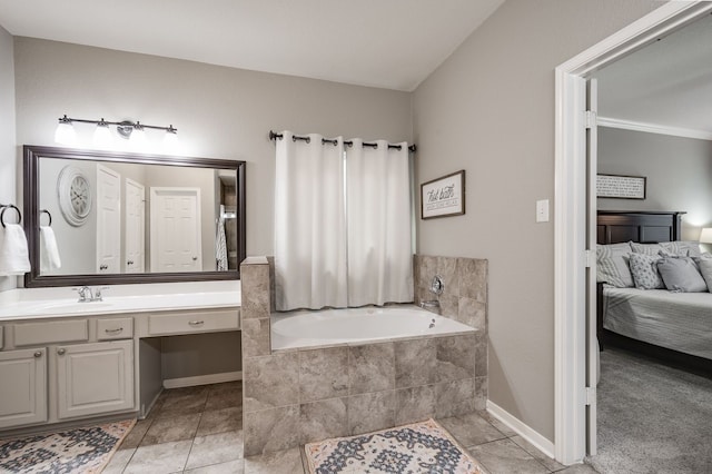 bathroom featuring tiled bath, tile patterned floors, crown molding, and vanity