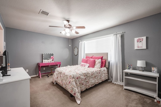 carpeted bedroom with a textured ceiling and ceiling fan