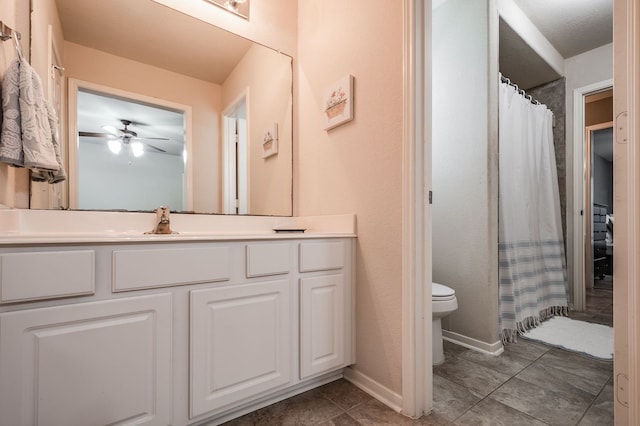 bathroom featuring toilet, ceiling fan, and vanity