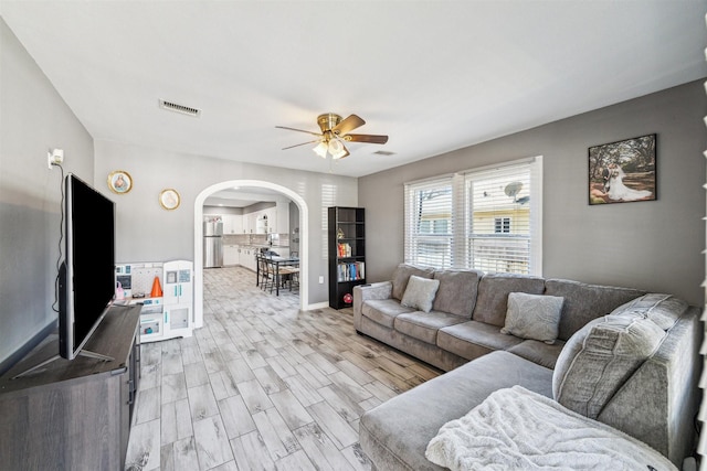 living room featuring ceiling fan and light hardwood / wood-style floors