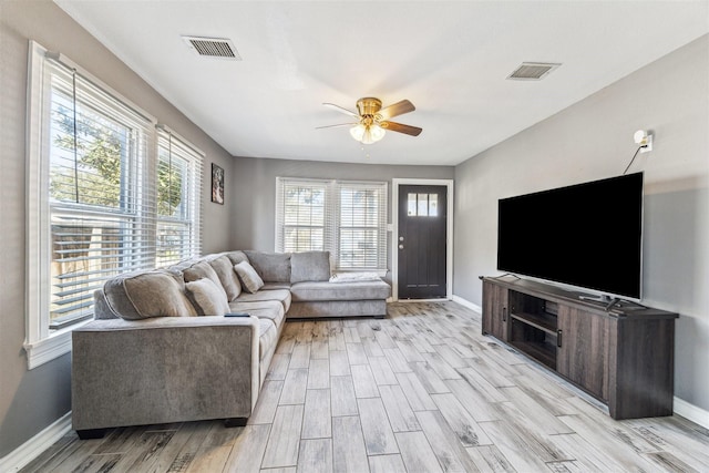 living room featuring ceiling fan and light wood-type flooring