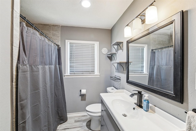 bathroom with toilet, a shower with curtain, and vanity