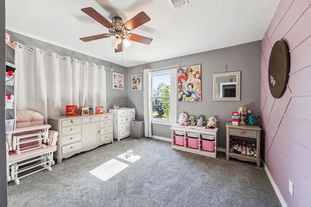 recreation room with ceiling fan and carpet