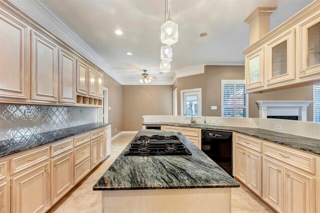 kitchen featuring black appliances, hanging light fixtures, a center island, ceiling fan, and sink