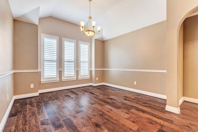 unfurnished room featuring a chandelier, lofted ceiling, and dark hardwood / wood-style floors