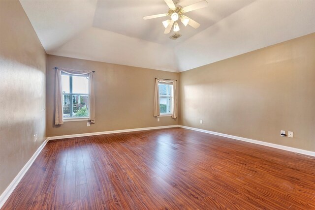 spare room featuring lofted ceiling, wood-type flooring, and ceiling fan