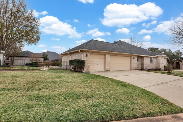 view of front of property with a front yard and a garage